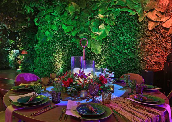 Tablescape with background of rainforest decorated walls.