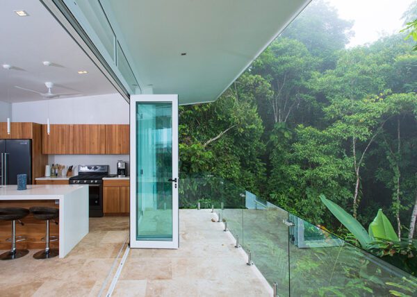 Sliding doors frame the landscape offering a unique connection with nature - Casa de Luz | Costa Verde Estates