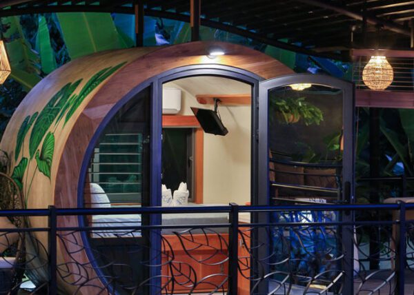 This is a disruptive architectural concept: concrete pipe accommodations surrounded by jungle, high end details like stained glass windows and wall arts of tropical lush plants - Saranda Boutique Hotel